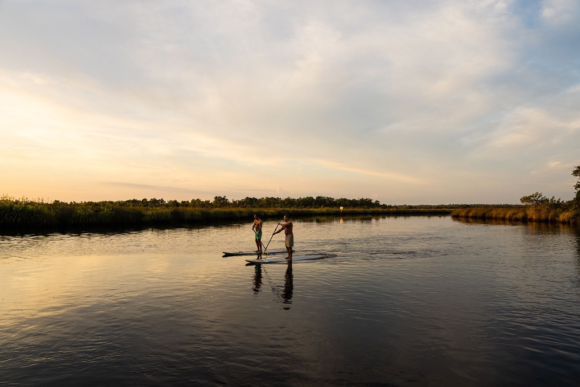 Paddleboarding at sunset on Tributary's waterways