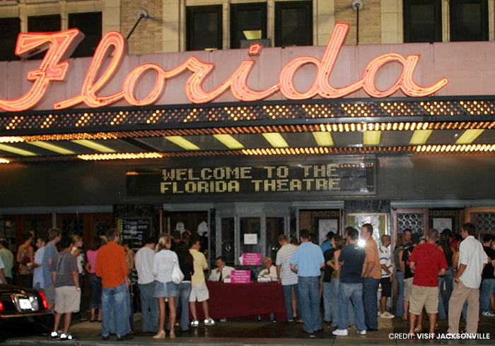a crowd gathered in front of the Florida theatre in downtown Jacksonville minutes away from Tributary