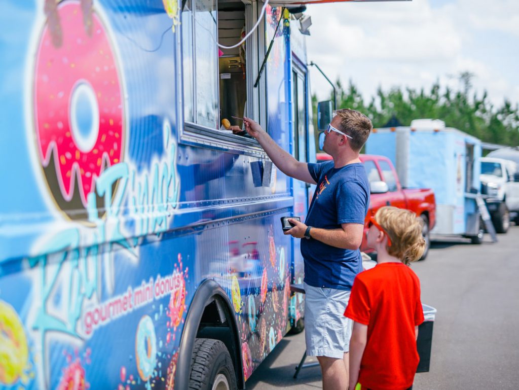 father and son at food truck at Tributary Model Home Event