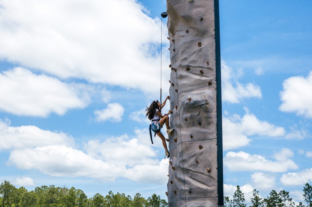 girl rock climbing at Tributary Model Home Event