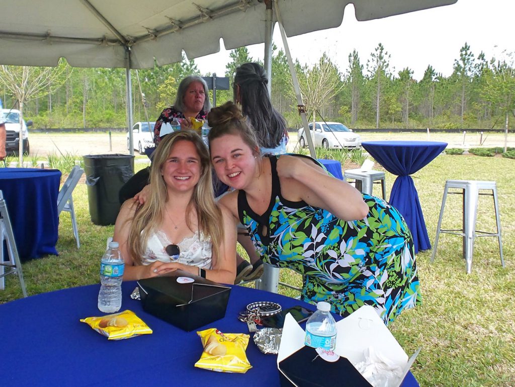 friends smiling at Tributary Model Home Event