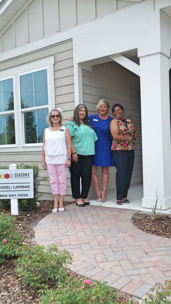 4 people outside of dream finders larimar model home at Tributary Model Home Event