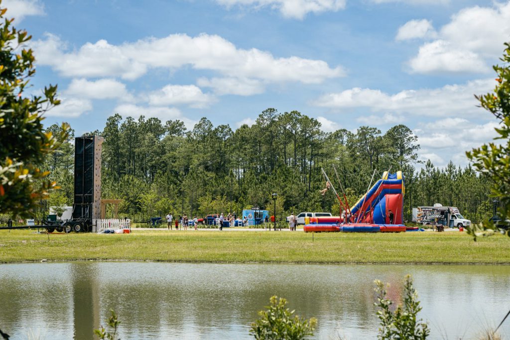 Tributary Model Home Event rock climbing and slide