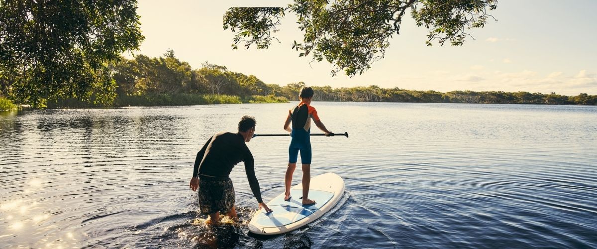 Father and son paddleboarding the nassau river