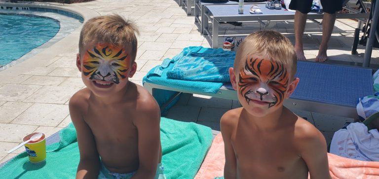 2 boys with face paint poolside