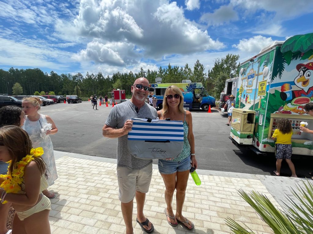 couple holding up a Tributary bag swag