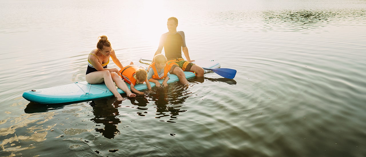 family on paddle board on the nassau river near tributary