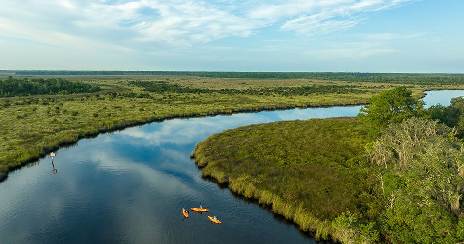 aerial image of 3 kayakers on the nassau river near tributary regional park