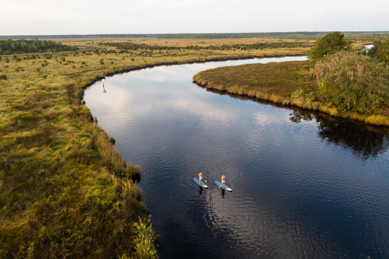 aerial of the nassau river with paddleboarders