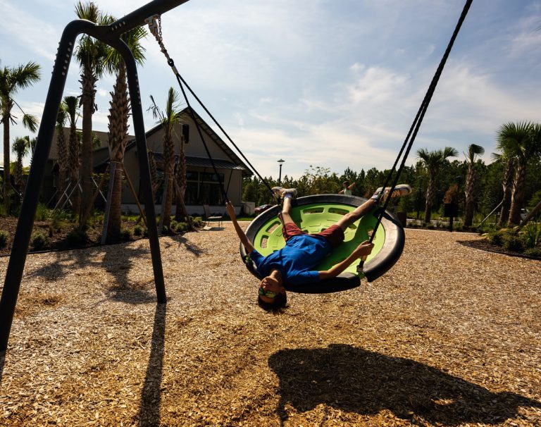 boy hanging upside down on the playground