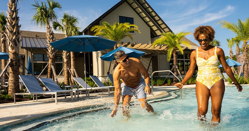 couple splashing in the pool - florida lifestyle director to plan pool parties