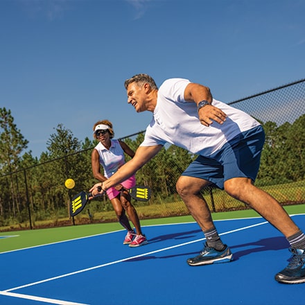 Active-Adults playing pickleball at Tributary - active-adult communities