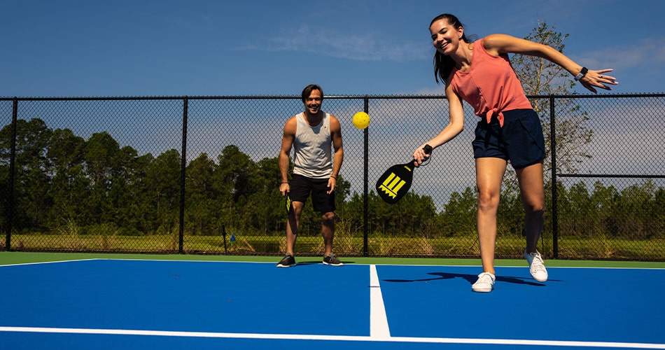 couple playing pickleball at tributary