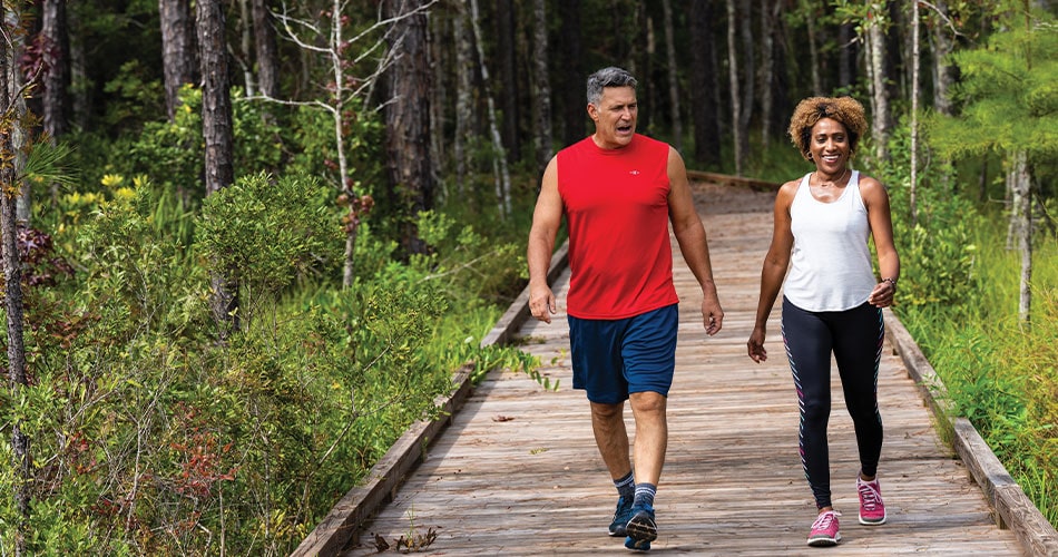 older couple hiking through master-planned community