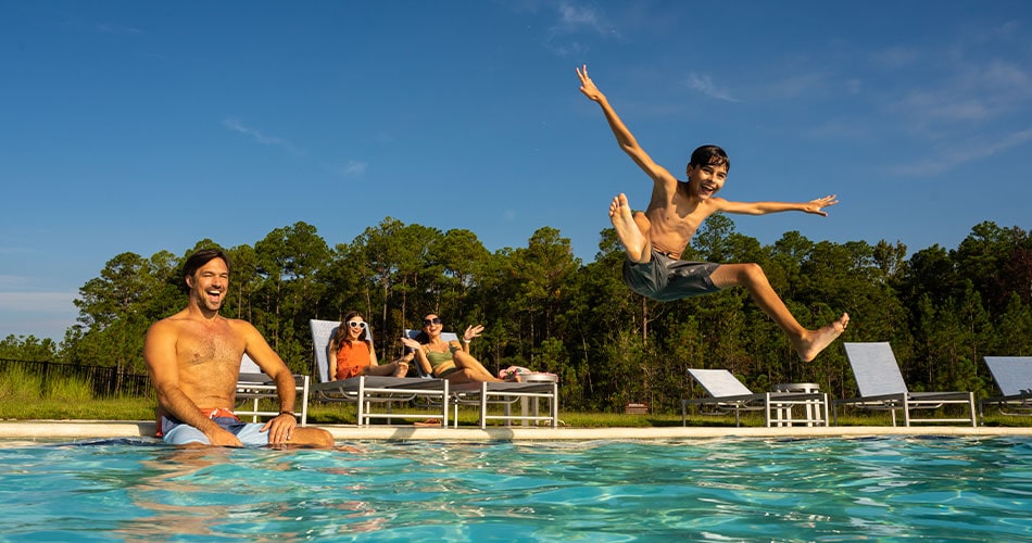 kid jumping in the pool at the Master-Planned Community at Tributary