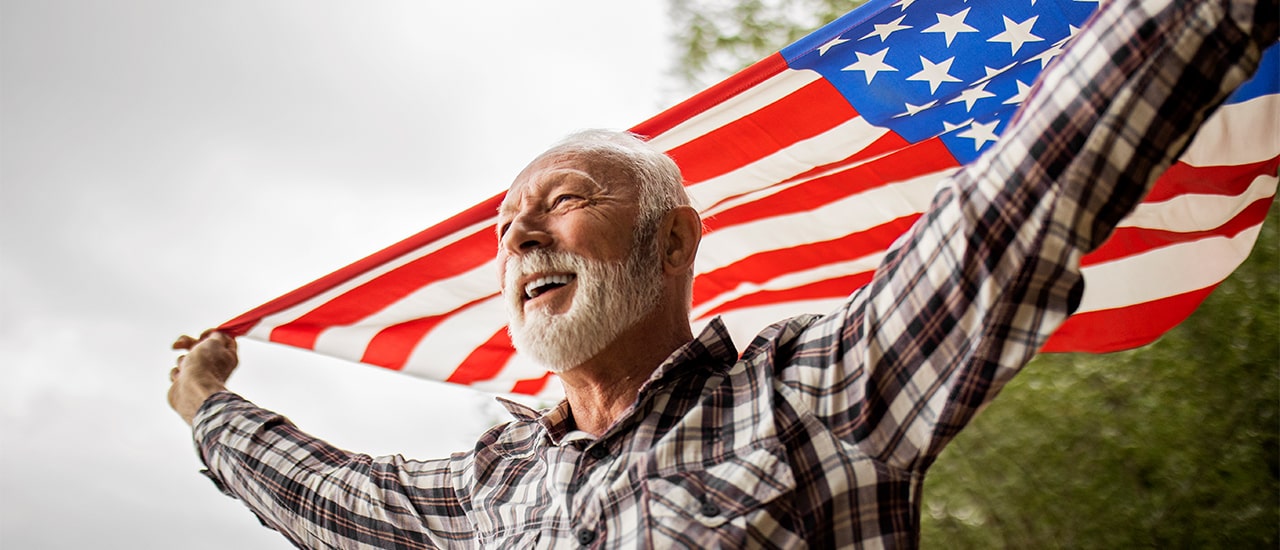 Veteran holding up flag