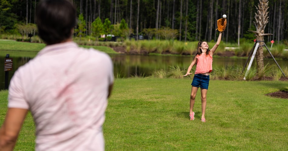 father and daughter playing catch in this community in North Florida 