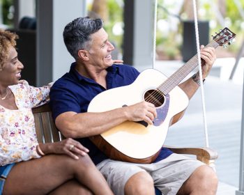 Couple on swing with guitar at Tributary