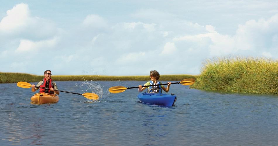 Couple kayaking through waterways near Yulee and Jacksonville, Florida.