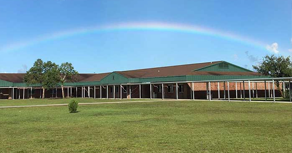 Yulee Middle School building with rainbow overhead in Nassau County, Florida.
